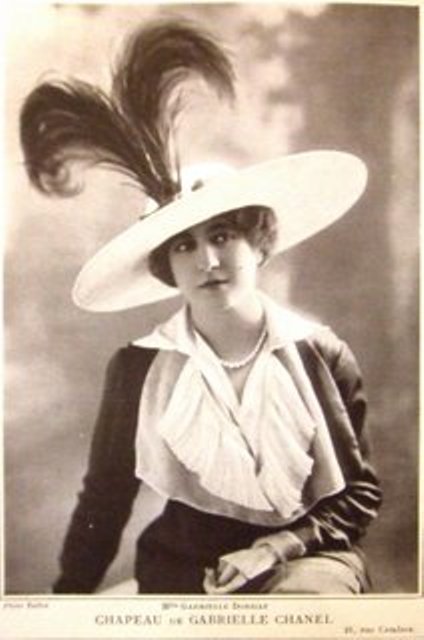 Gabrielle Coco Chanel wearing one of her hats in 1912